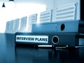 Interview Plans on Office Binder. Blurred Image.
