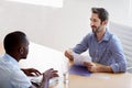 Interview in progress...a businessman interviewing a job applicant in an office.