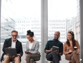 Interview, technology and business people in waiting room of office for human resources meeting or recruitment. App Royalty Free Stock Photo