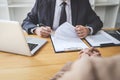 Interviewer or Board reading a resume during a job interview, Employer interviewing a young female job seeker for recruitment