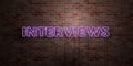 INTERVIEWS - fluorescent Neon tube Sign on brickwork - Front view - 3D rendered royalty free stock picture