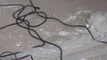The interweaving of black wires on the concrete floor during the renovation of the house
