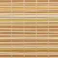 Interwoven bamboo mat comprising thin, round sticks in various Royalty Free Stock Photo