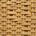Interwoven pattern made from light brown, flat strips resembling rattan or wicker. Royalty Free Stock Photo