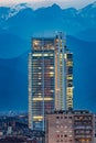 Intesa Sanpaolo tower, night view with the Alps in background.