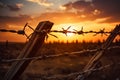 A barbed wire fence outlined against a resplendent sunset