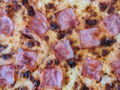 An intimate gaze at a pizza masterpiece, adorned with savory ham