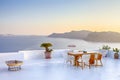 Intimate Romantic Places. Open Air Terrace Restaurant in Beautiful Oia Village on Santorini Island in Greece in Front of Volcanic Royalty Free Stock Photo