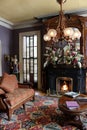 Intimate setting with comfy couches, fireplace, and floral arrangements, The Mansion Inn, 2019