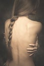 Intimate woman portrait bare back and long braid Royalty Free Stock Photo