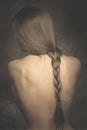 Intimate woman portrait bare back and long braid