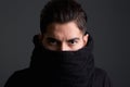 Intimidating young man with scarf covering face Royalty Free Stock Photo