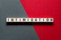 Intimidation - word concept on cubes