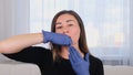 Intra oral neuromuscular massage. Female professional beautician makes facial massage to herself