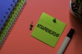 Intrapreneurship write on sticky notes. Isolated on pink table background Royalty Free Stock Photo