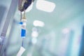 Intravenous drip with blue content on the pole in the hospital hallway Royalty Free Stock Photo