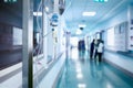 Intravenous drip in the hospital corridor against the blurred figure of medical staff Royalty Free Stock Photo