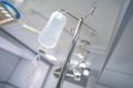 Intravenous or Iv fluids drip bottle hanging on a metal pole in hospital emergency room Royalty Free Stock Photo