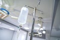 Intravenous or Iv fluids drip bottle hanging on a metal pole in hospital emergency room Royalty Free Stock Photo