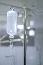 Intravenous or Iv fluids drip bottle hanging on a metal pole in hospital emergency room Royalty Free Stock Photo