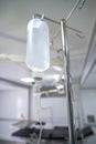 Intravenous or Iv fluids drip bottle hanging on a metal pole in hospital emergency room Royalty Free Stock Photo