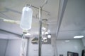 Intravenous or Iv fluids drip bottle hanging on a metal pole in hospital emergency room Royalty Free Stock Photo