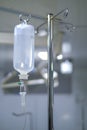 Intravenous or Iv fluids drip bottle hanging on a metal pole in hospital emergency room Royalty Free Stock Photo