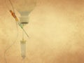 Intravenous medical perfusion system on old paper background Royalty Free Stock Photo