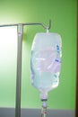 Intravenous solution bag hanging on saline metal pole