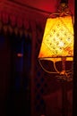 Intricate antique lampshade with beautiful detailing in dimly lit hotel room. Fancy and luxurious feeling with vintage light Royalty Free Stock Photo