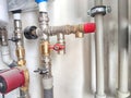 An intricate array of pipes and valves behind the scenes. Complex Plumbing Configuration Behind a Public Restroom Wall Royalty Free Stock Photo