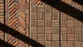 Intricate brick pattern with crosshatched and basketweave designs highlighted by sunlight and shadow Royalty Free Stock Photo