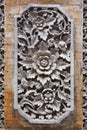 Intricate carved stone cartouche at an ancient temple in Bali Indonesia