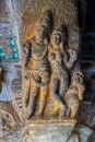 Intricate carving of an amorous couple on bracket figure in cave