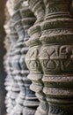 Intricate carving details on ancient window columns or pillars selective focus from sandstone in Angkor Wat temple complex in Royalty Free Stock Photo