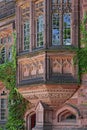 Intricate carving in its reddish sandstone around this oriel window