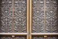 intricate carvings on the door of a mausoleum