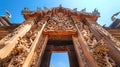 Intricate carvings on Thai temple doors. Elaborate temple entrance with traditional Thai Buddhist art. Concept of