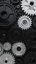 Intricate close up of interlocking black and silver gears and cogs of various sizes creating a complex mechanical industrial Royalty Free Stock Photo