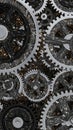 Intricate close up of interlocking metallic and dark textured gears and cogs creating a complex mechanical system with a gritty Royalty Free Stock Photo