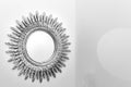 Intricate design metal mirror on white wall Royalty Free Stock Photo