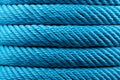 Intricate Detail of Blue Thread Wrapping Around Spool, Close-Up Textured Pattern on Background