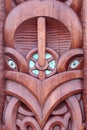 Maori design carving in wood with paua shell eyes Royalty Free Stock Photo