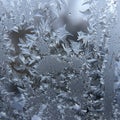 Intricate frost patterns form on a window, displaying a delicate array of ice crystals Royalty Free Stock Photo