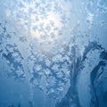Intricate frost patterns on a window with sunlight shining through Royalty Free Stock Photo
