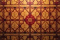 Intricate geometric design in warm tones featuring a repeating pattern of interlocking shapes and symmetrical elements on a Royalty Free Stock Photo