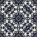 Intricate geometric pattern featuring dark petal-like motifs arranged in a