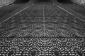 Intricate geometric patterns cover a large architectural surface, creating a mesmerizing design. black and white jaali Royalty Free Stock Photo
