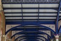 Intricate ironwork decorative roof trusses details at the Liverpool Train Station in London, United Kingdom