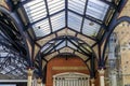 Intricate ironwork decorative roof trusses details at the Liverpool Train Station in London, United Kingdom